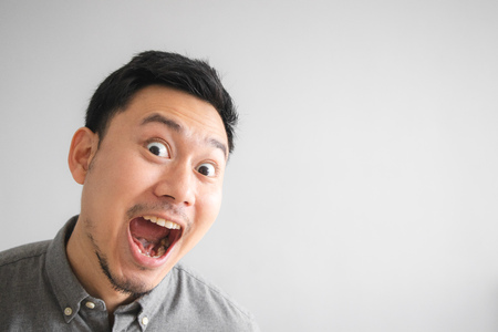 Wow and surprised face of funny good looking Asian man.の写真素材