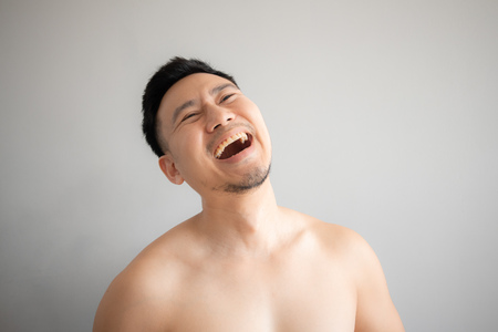 Laugh face of man in topless portrait isolated on gray background.の写真素材
