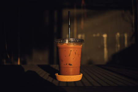 Close up of Ice Chocolate in a plastic glass on black table.