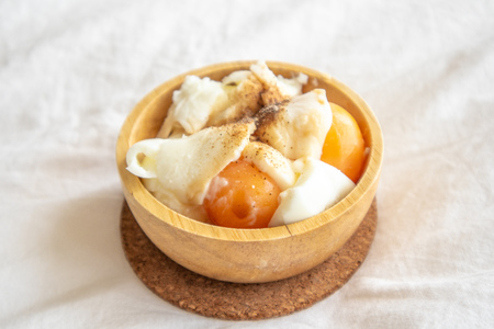 Soft boiled eggs with pepper and salt served in wooden cup.の写真素材