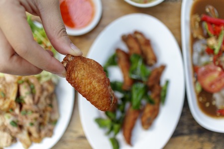 Close up of Thai deep fried chicken wing tips.の写真素材
