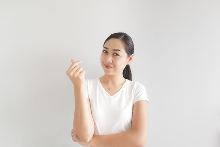 Smile and happy Asian woman in white t-shirt. Concept of happy and thinking positive.の写真素材