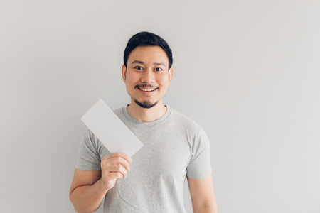 Asian man is happy with the white mail message or the bill.の写真素材