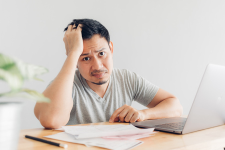 Sad Asian man has problems with billing and debts.の写真素材