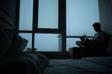 Sad vibe of a condominium room with raining outside.の写真素材