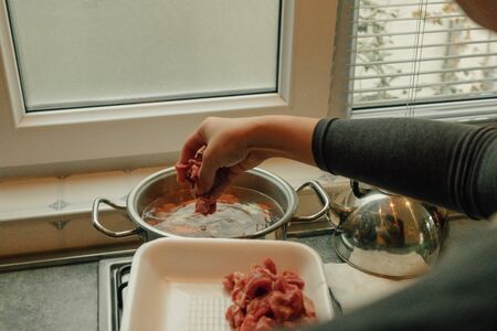 Cooking breakfast beef soup with variety of vegetables at the kitchen in the morning.の写真素材