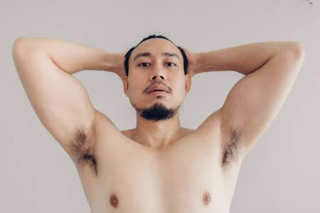 Topless Asian man is trying to be handsome.の写真素材
