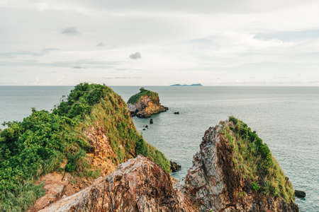 Beautiful cliff and coast with calm sea and cloudy sky.の写真素材