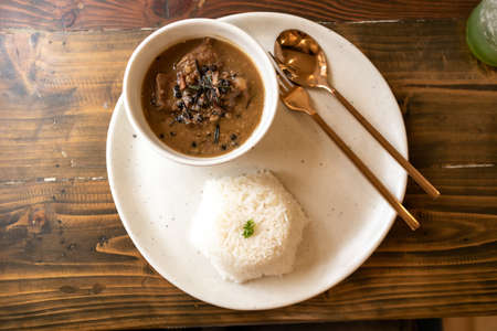 Beef stew with spices set is served on a classic wooden table.の写真素材