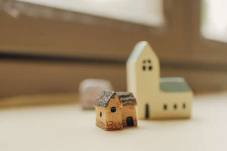 Tiny simple resin houses decorated on the edge of windows.の写真素材