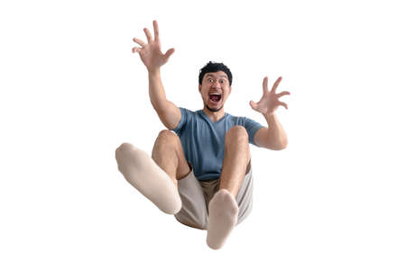 Funny full body of shocked Asian man being blown away on isolated background.