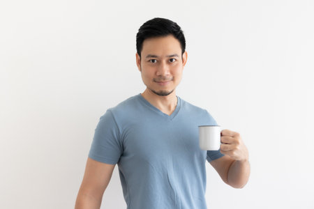 Happy smile face of Asian man drinks coffee on isolated background.の写真素材