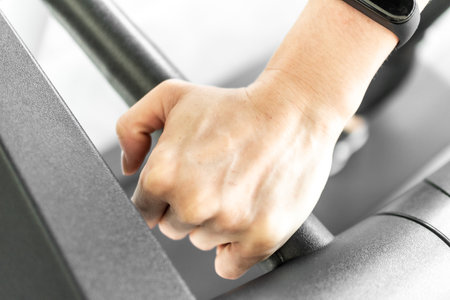 Close up of woman on treadmill. Concept of woman body part and workout.