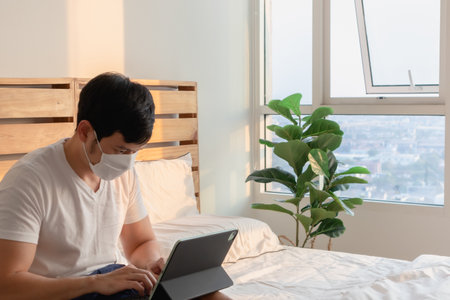 Asian man is in an online meeting in concept of work from home.