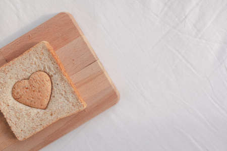 Grained bread cut off as heart shape. Concept of love and care in Valentine day.の写真素材
