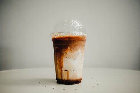 Fresh iced coffee with milk on white table.の写真素材