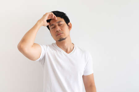 Serious and upset Asian man wears white t-shirt isolated on white background.の写真素材