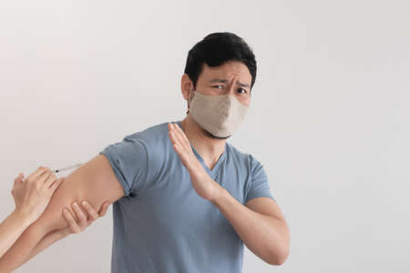 Asian man is being injected a vaccine for virus protection. Concept of vaccination.の写真素材