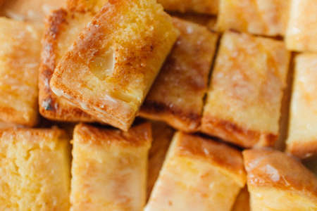 Thai Condensed Milk Toast served on wooden plate on black table.の写真素材