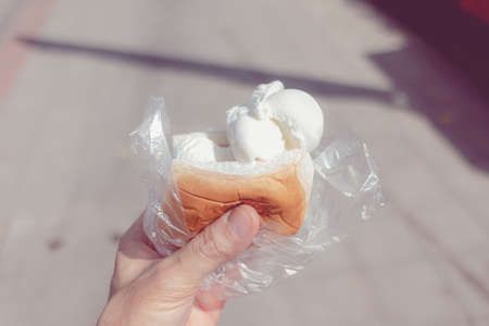 Thai coconut iced-cream in soft bread. Very popular Thai dessert in hot day.の写真素材