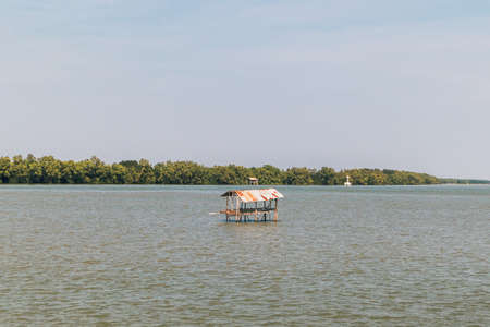 Small hut in the middle of the sea to guard the fishing net area in Thailand.の写真素材