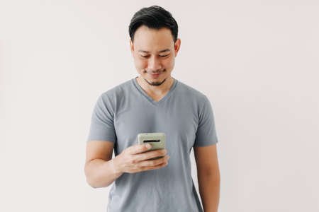 Happy Asian man use smartphone isolated on white background.