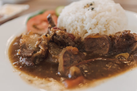Thai stewed beef with rice served on white dish in the cafe.の写真素材