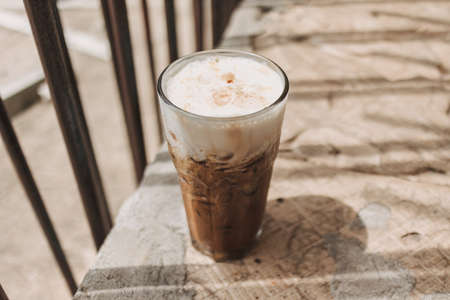 Iced cappuccino coffee drink in a tall glass. Concept of summer refreshment drink.の写真素材
