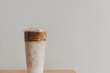 Iced coffee milk served in a tall plastic cup.の写真素材