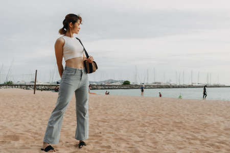 Asian woman walk on the beach in summer. Concept of summer holiday.の写真素材
