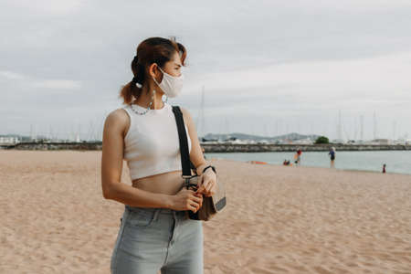 Asian woman walk on the beach in summer. Concept of summer holiday.