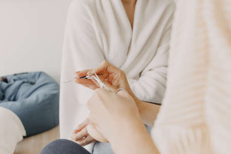 The makeup artist is using makeup tools applying to the client.