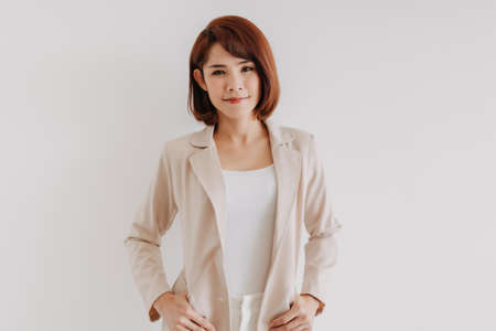 Asian office woman in white clothes and creamy casual suit on white background.の写真素材