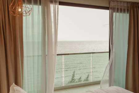 Chill terrace of hotel with sea view and table set in summer vacation.の写真素材