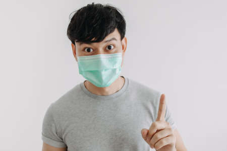 Close up of Happy Asian man wears mask isolated on white background.の写真素材