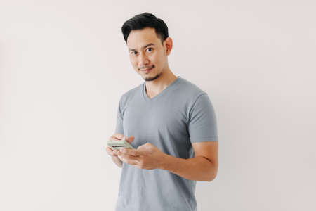 Happy Asian man use smartphone isolated on white background.の写真素材