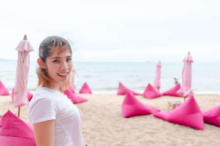 Asian woman relax on the pink cafe beach summer in Thailand.の写真素材