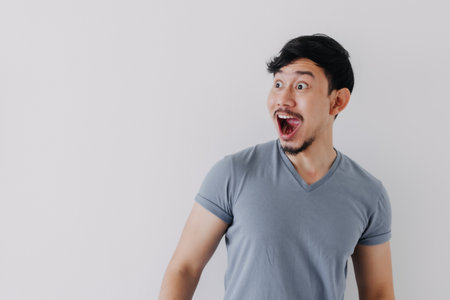 Shocked and surprised face of Asian man in isolated on white background.の写真素材