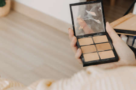 The makeup artist is using makeup tools applying to the client.の写真素材