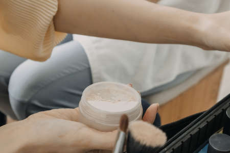The makeup artist is using makeup tools applying to the client.の写真素材