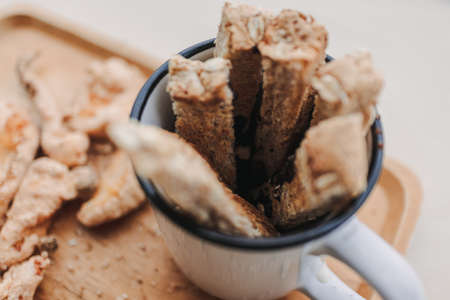 Set of bread chocolate dips with hot cocoa on wooden plate.の写真素材