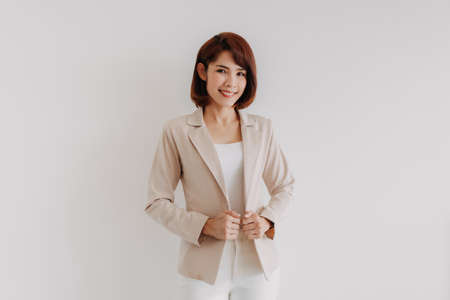 Asian office woman in white clothes and creamy casual suit on white background.の写真素材