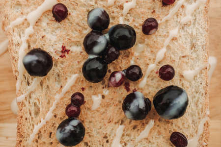 Homemade mixed berries toast breads served on wooden plate.の写真素材