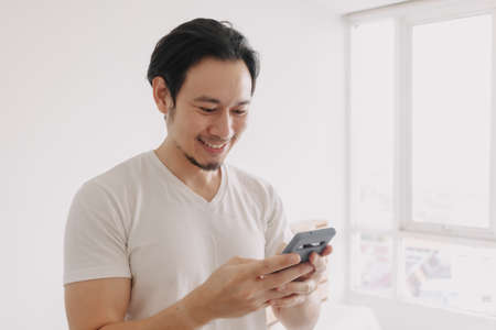 Happy and smile face of Asian man using smartphone.の写真素材
