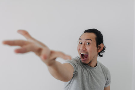 Excited and wow face of Asian man proud to present advertisement.