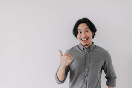 Happy wow face Asian man present an empty space of advertisement promotion.の写真素材