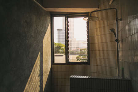 Domestic dark bathroom with sunlight through the windows. High quality photo