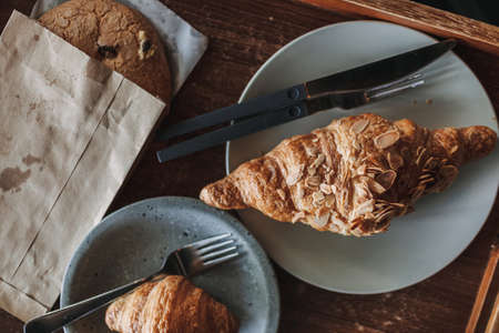 Woman is having croissant and iced lemon tea in the cafe. High quality photoの写真素材