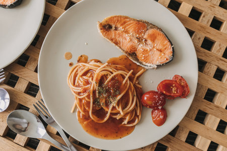 Homemade salmon spaghetti with tomato sauce served for lunch.の写真素材