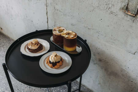 Dessert set of scones and americano coffee for couple served in cafe.の写真素材